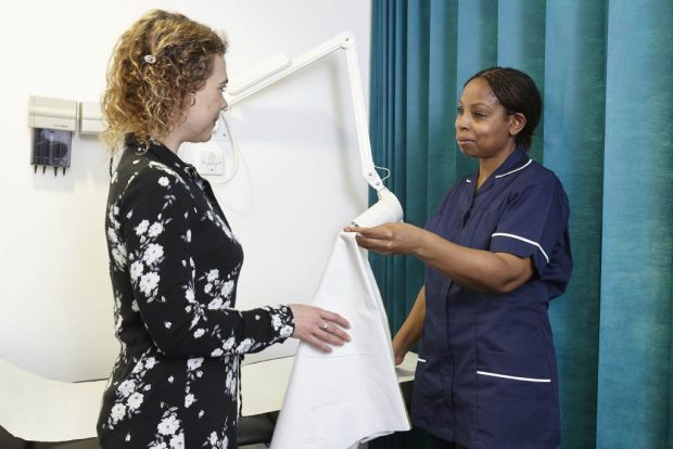 A nurse speaking to a female patient