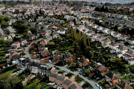 Image of houses on a UK street.