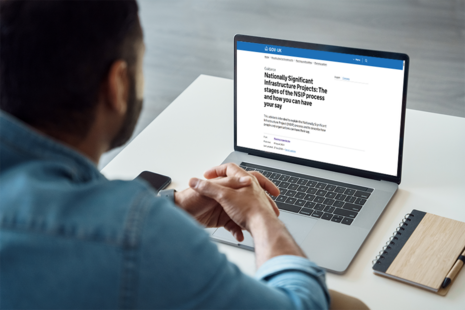 Person sat at computer looking at website