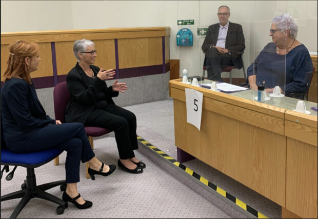 Deaf juror with BSL interpreter in courtroom