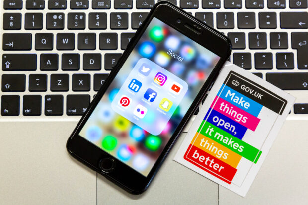 An iPhone displaying the social media icons for Facebook, Twitter, Instagram, Pinterest, Snapchat and LinkedIn