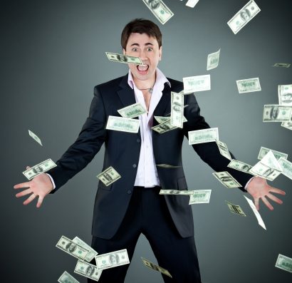 Happy man throwing money in the air