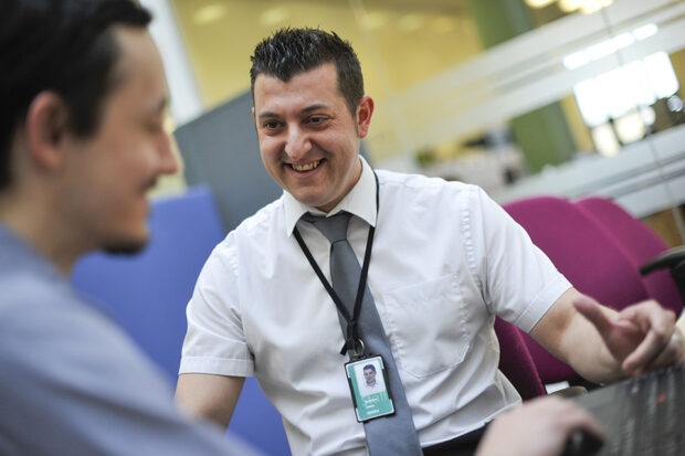 2 of DVLA's Science, Technology, Engineering and Mathematics (STEM) ambassadors sitting by a laptop keyboard