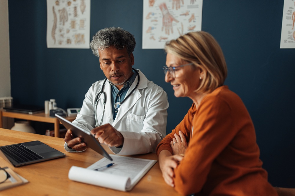 An attentive doctor provides essential health information to a patient, ensuring clarity and fostering a supportive environment for discussing medical concerns and treatment. (Credit: iStock Photo)