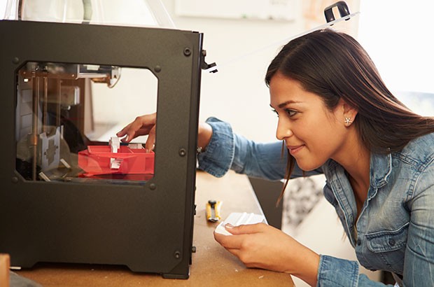 Image of a female using a 3D printer.