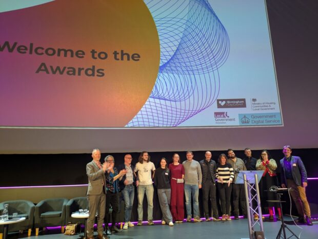 Team Match on stage with the judges after presenting their winning, data-driven prototype for intelligently matching individuals with suitable temporary accommodation.