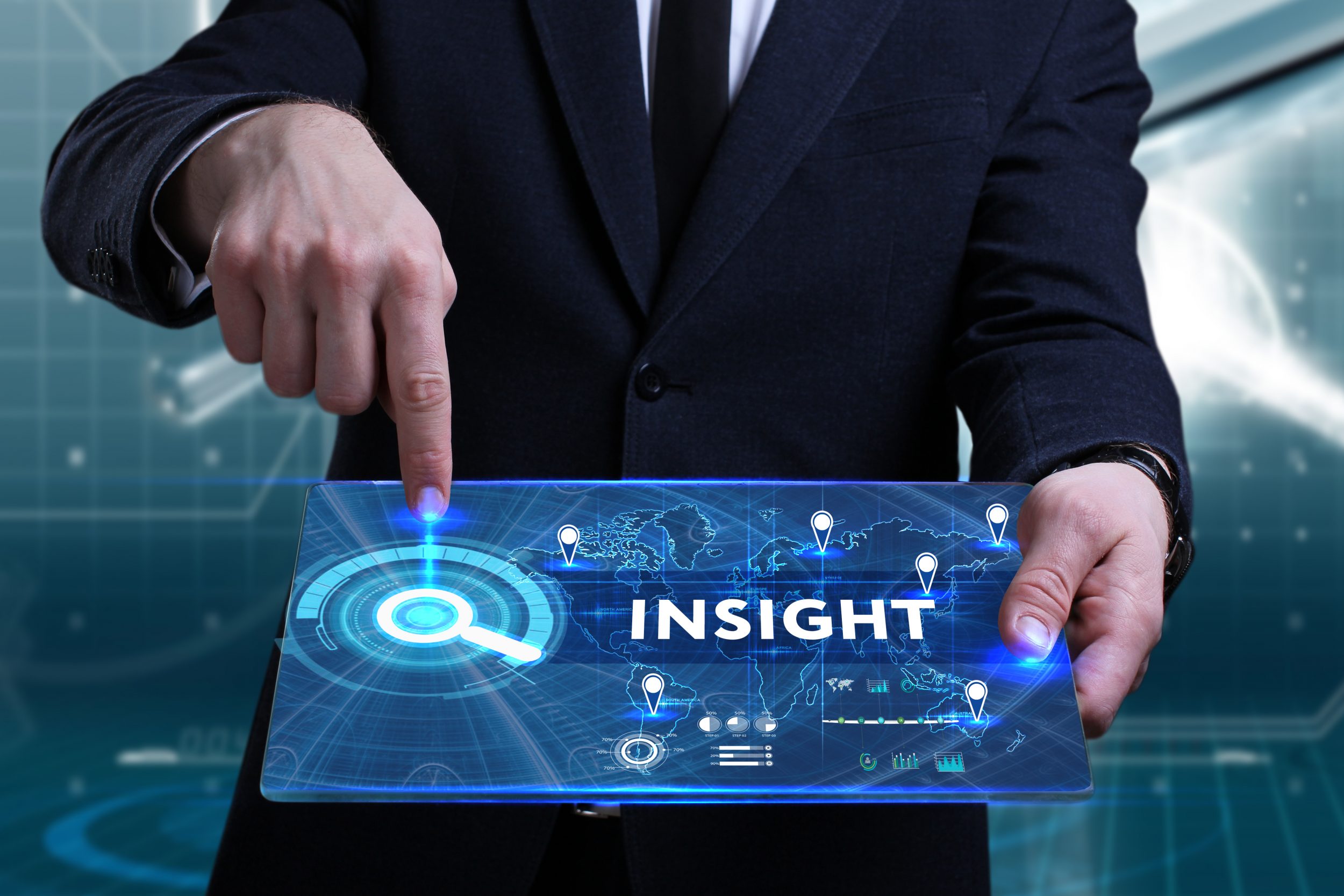 Image of man pointing to the word Insight on a screen he is holding in front of him.
