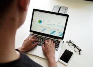 Person looking at data on a laptop
