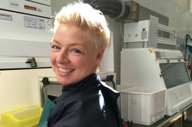 Adrienne working in a microbiological safety cabinet