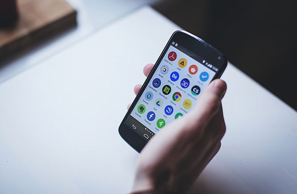 Mobile phone with apps on screen.