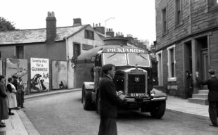 The heat exchangers coming through Egremont on a truck over the Ehen Bridge in black and white
