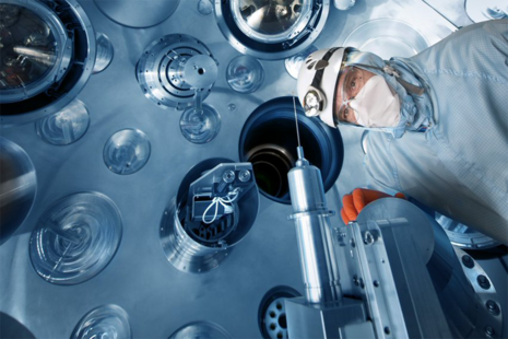 A person wearing PPE working at the Orion Laser Facility