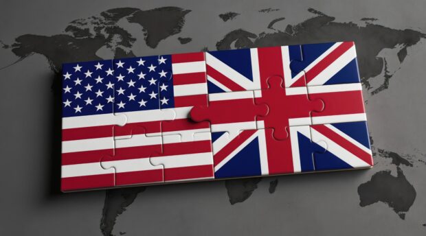 A jigsaw of the US flag and the Union Jack over a world map.