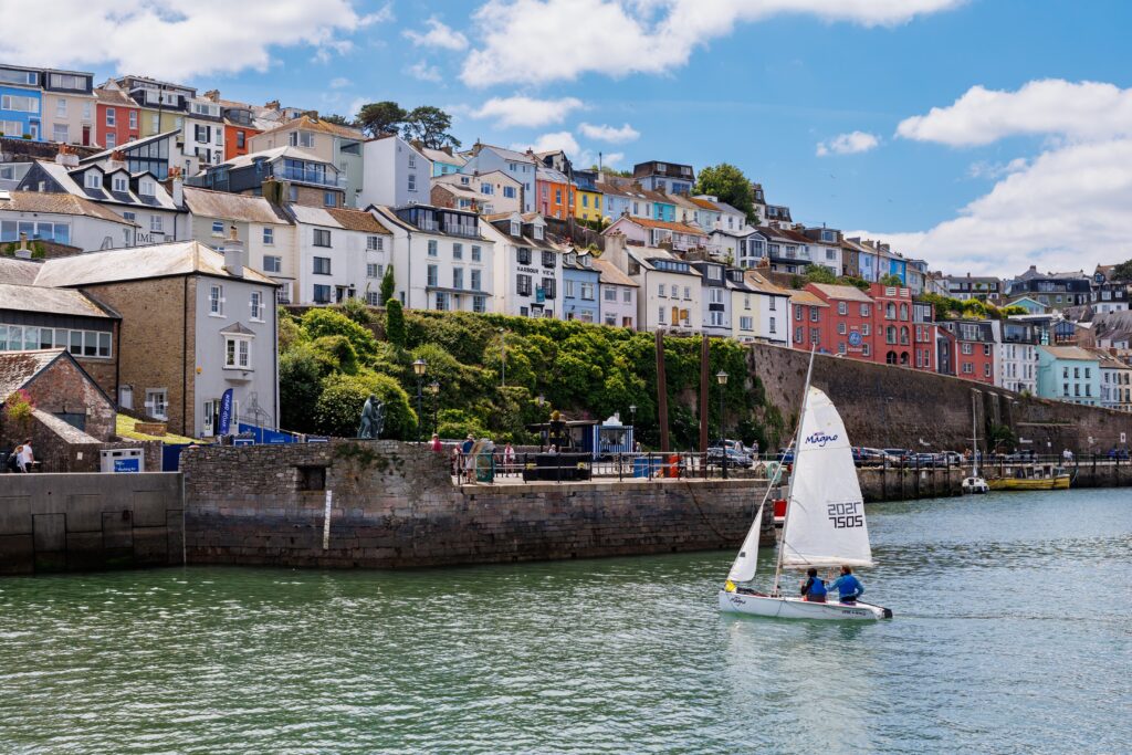 Colourful harbour houses with sailboat on water