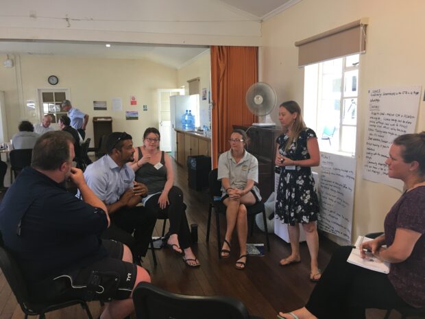 People sitting in a circle talking at a workshop