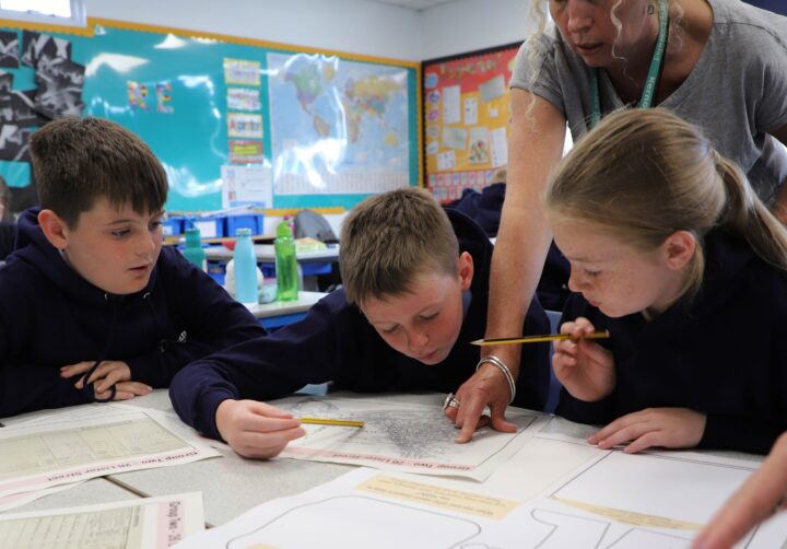 Three students explore a document