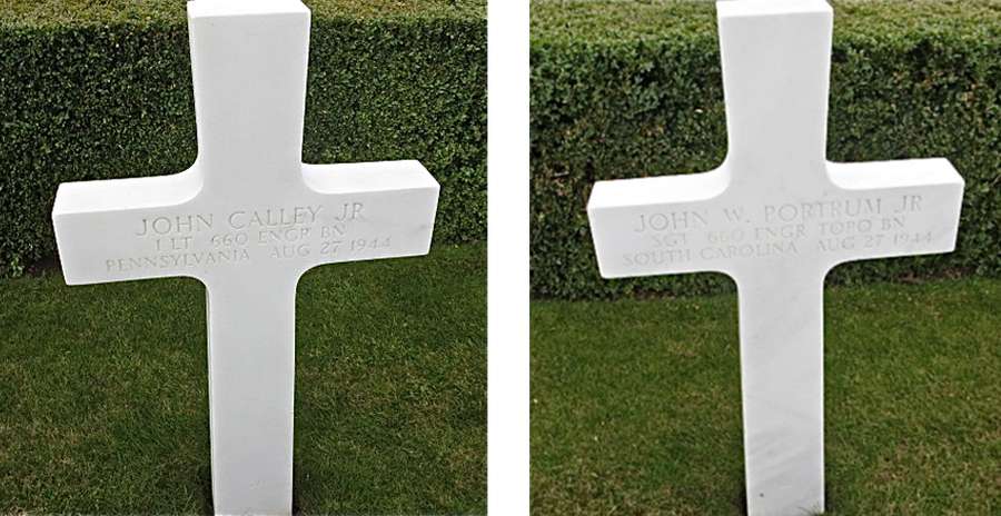 Two white crosses with name, military unit and date of death engraved into them, standing on well-kept grass.