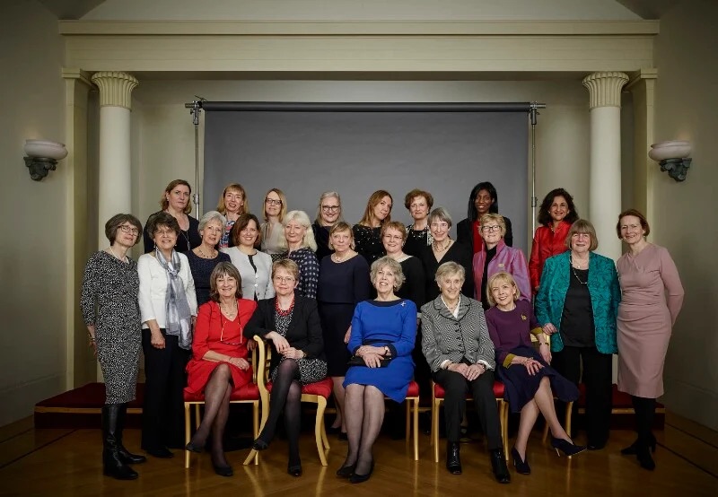 2017 Female Permanent Secretaries pose for a portrait in front of a grey wall