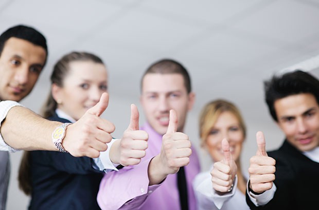 Image of business owners with their thumbs up.
