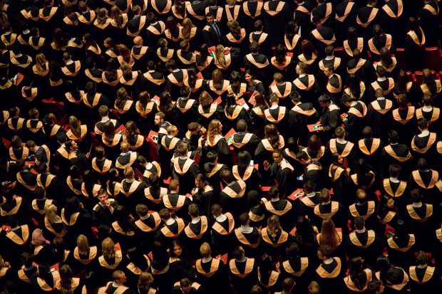 A birds eye view of a large crowd of graduates.