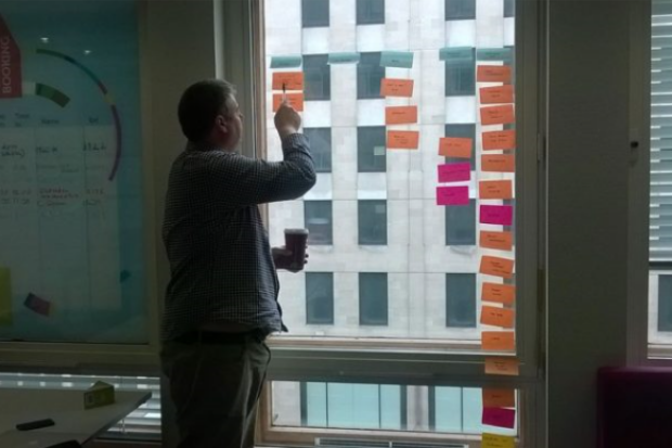 Mark Dalgarno (delivery manager at the Department for Education) looking at notes in a meeting