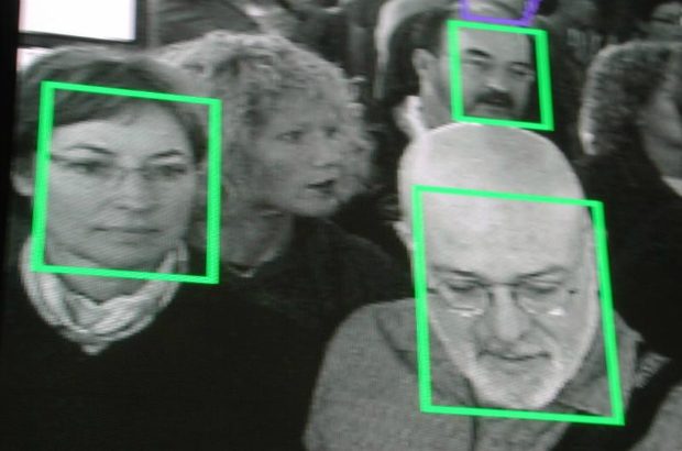 Photo of people with some faces surrounded in squares