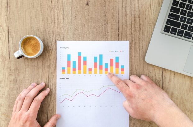 An individual analysing a chart at a desk