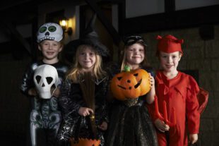 Children trick or treating in Halloween costumes. This blog gives tips on avoiding counterfeit costumes and staying safe at Halloween.