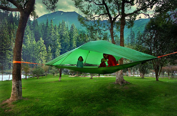 Image of a family within a Tentsile in the forest.