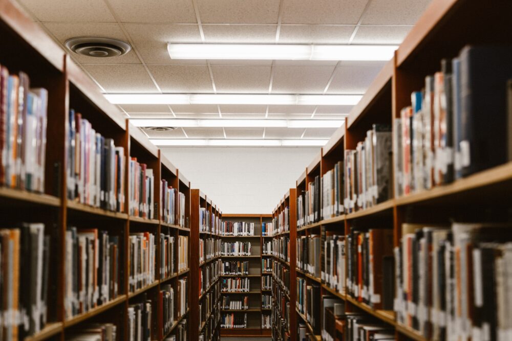 Interior of a library, with hundreds of books in bookcases.