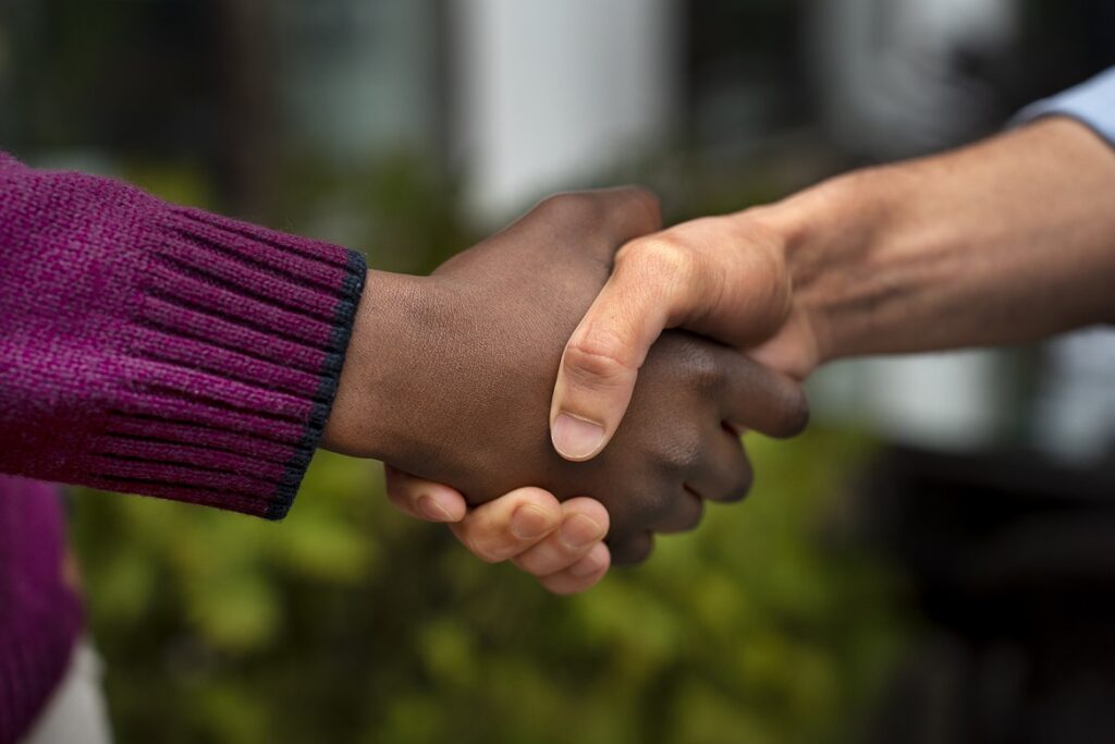 Carer and care user shaking hands