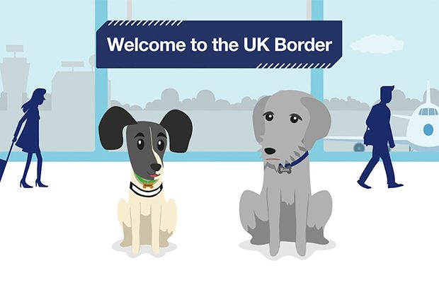 Still image from the Design102 animation showreel featuring work from their Border Paws animation work for Border Force. Two different types of illustrated dog are positioned against an illustration of an airport arrivals area, beneath a banner sign that reads 'Welcome to the UK border'.