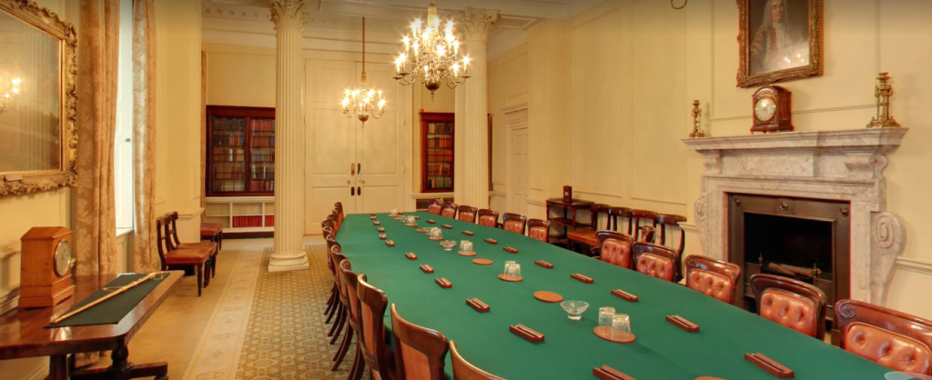 The Cabinet Room at No. 10 Downing Street is dominated by the Cabinet table with its green covering - above it is a chandelier