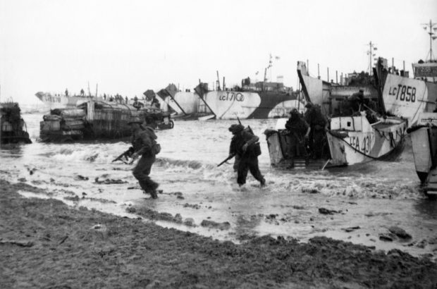 Commandos are seen here wading ashore from landing craft, onto the beaches of Normandy, June 1944 © Crown Copyright