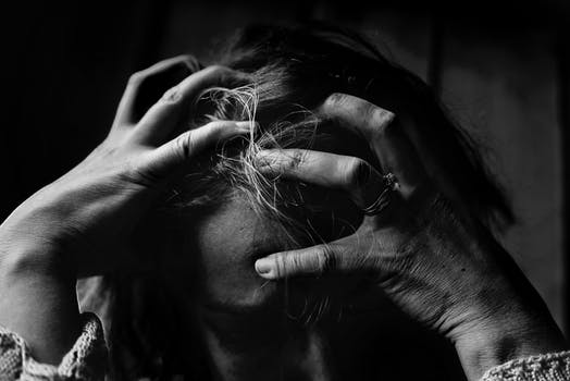 Woman with head in hands looking stressed