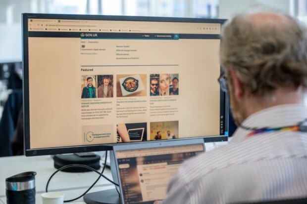 A person using GOV.UK on a monitor.