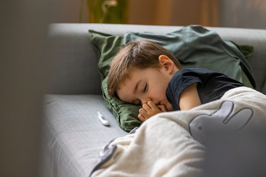 Young boy lying on a sofa