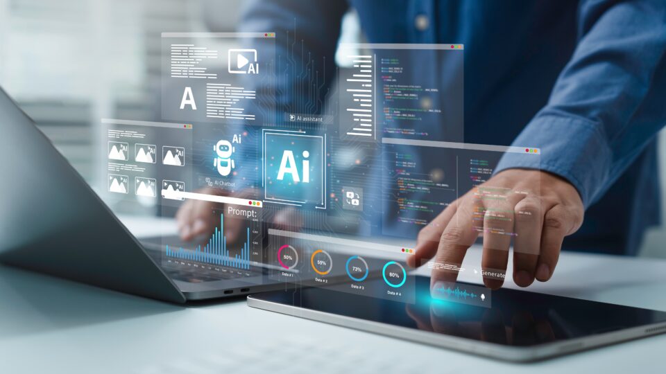A man standing at a desk uses a laptop and a tablet simultaneously, behind a screen of transparent technology-related icons.