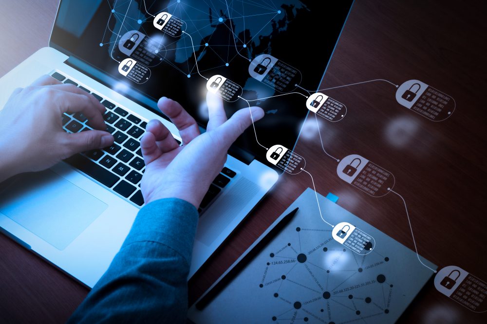 Man's hand pointing to blockchain technology images.