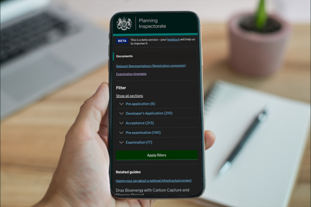 Person looking at a mobile phone showing the applications service documents page