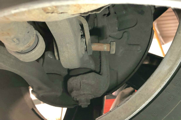 image of loose mounting bolt about to fall out