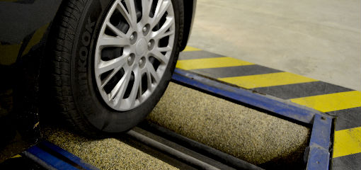 car wheel on roller brake tester machine