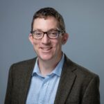A headshot photograph of Chris Playford