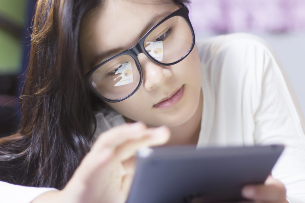 Woman using a tablet in bedroom