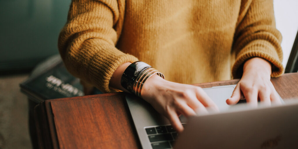 A person typing on a laptop.