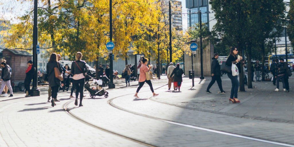 People walking along a street in Manchester, UK.