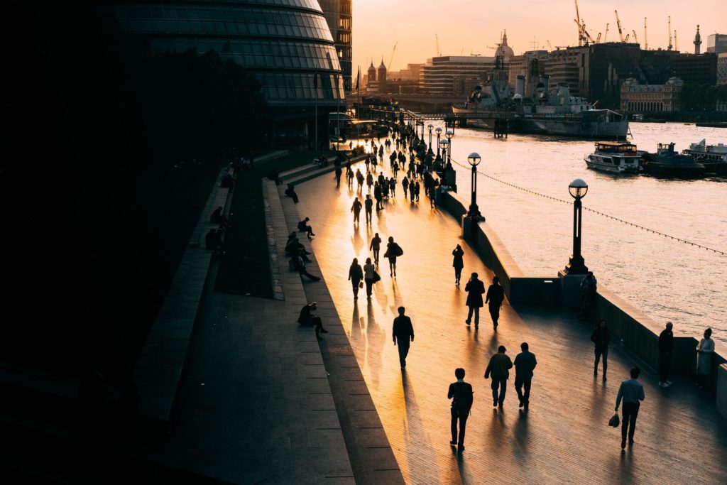 People walking by a river