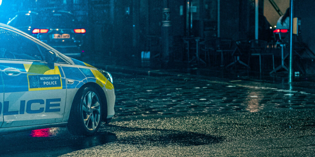 A police car parked on a street in London.