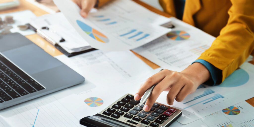 Person doing accounting calculations, illustrating the Family Finance Surveys User Conference.