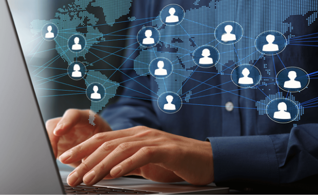 Hands typing on a laptop. A graphic showing a map of the world with a network of human icons is superimposed on top.